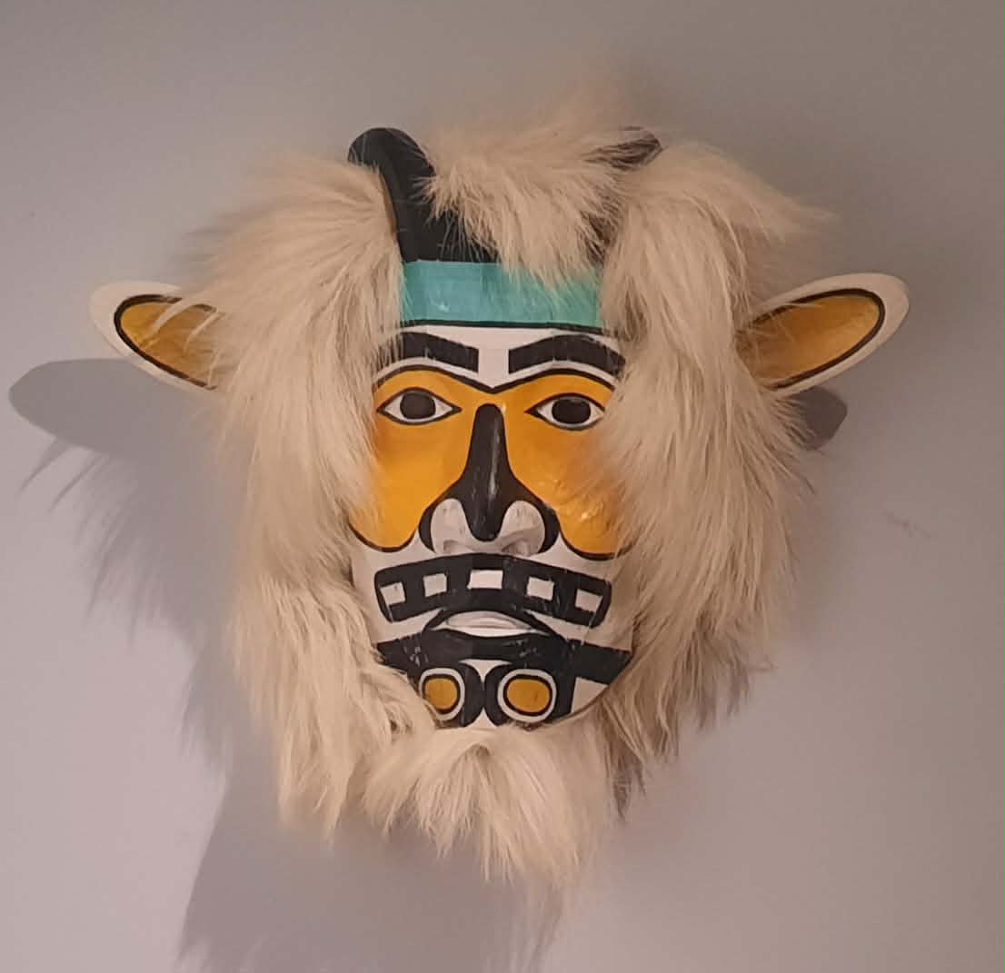Carved mask with fur mane and small horns