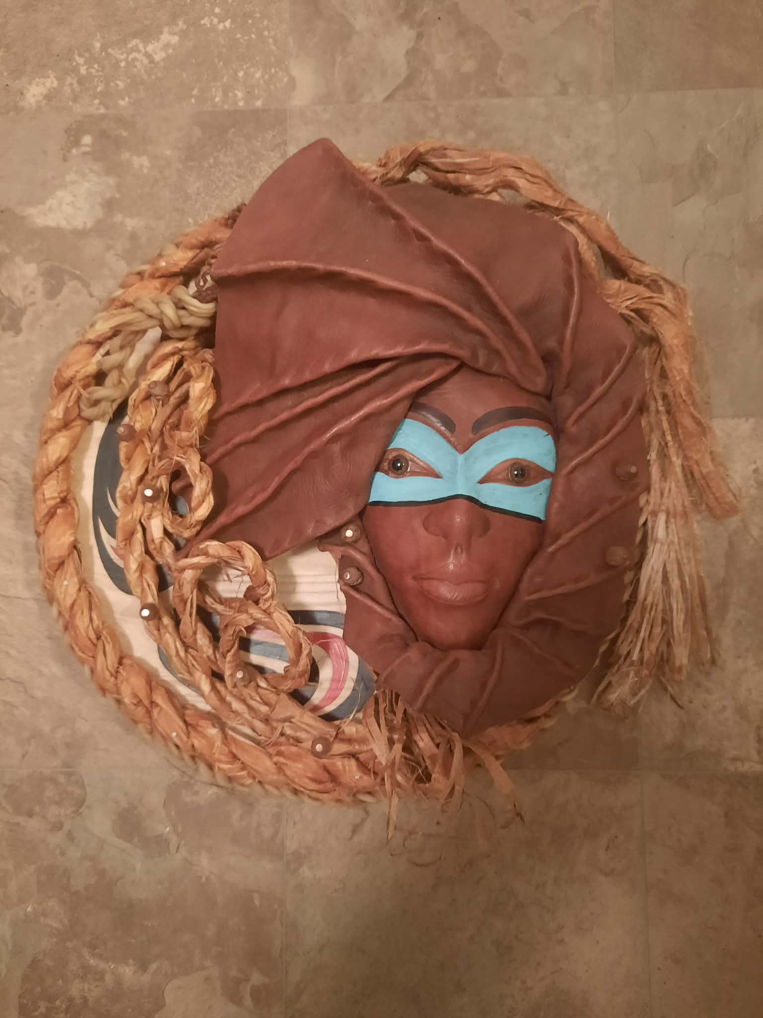 Carved mask with painted hide draping